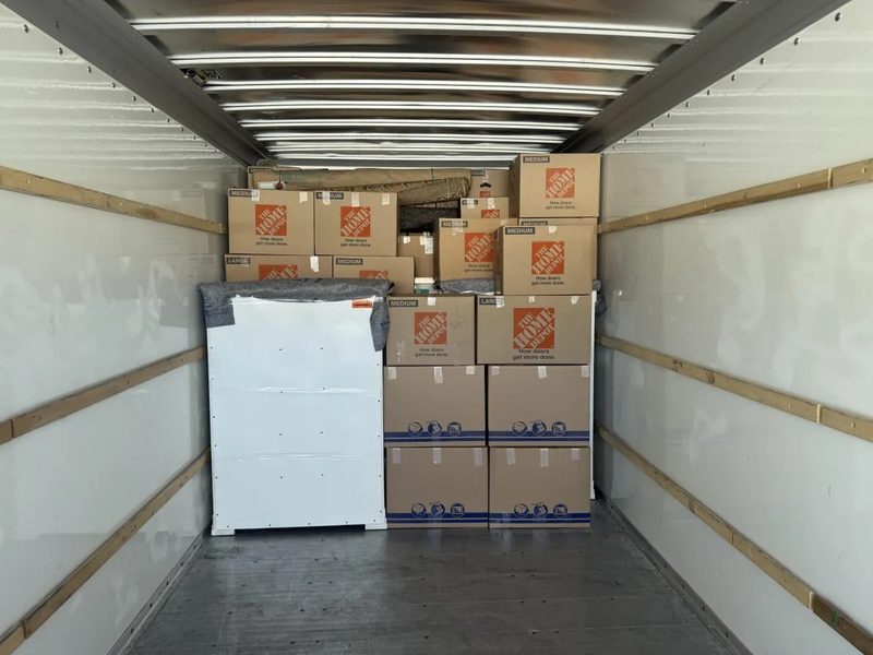 A trailer loaded with furniture ready to leave the property