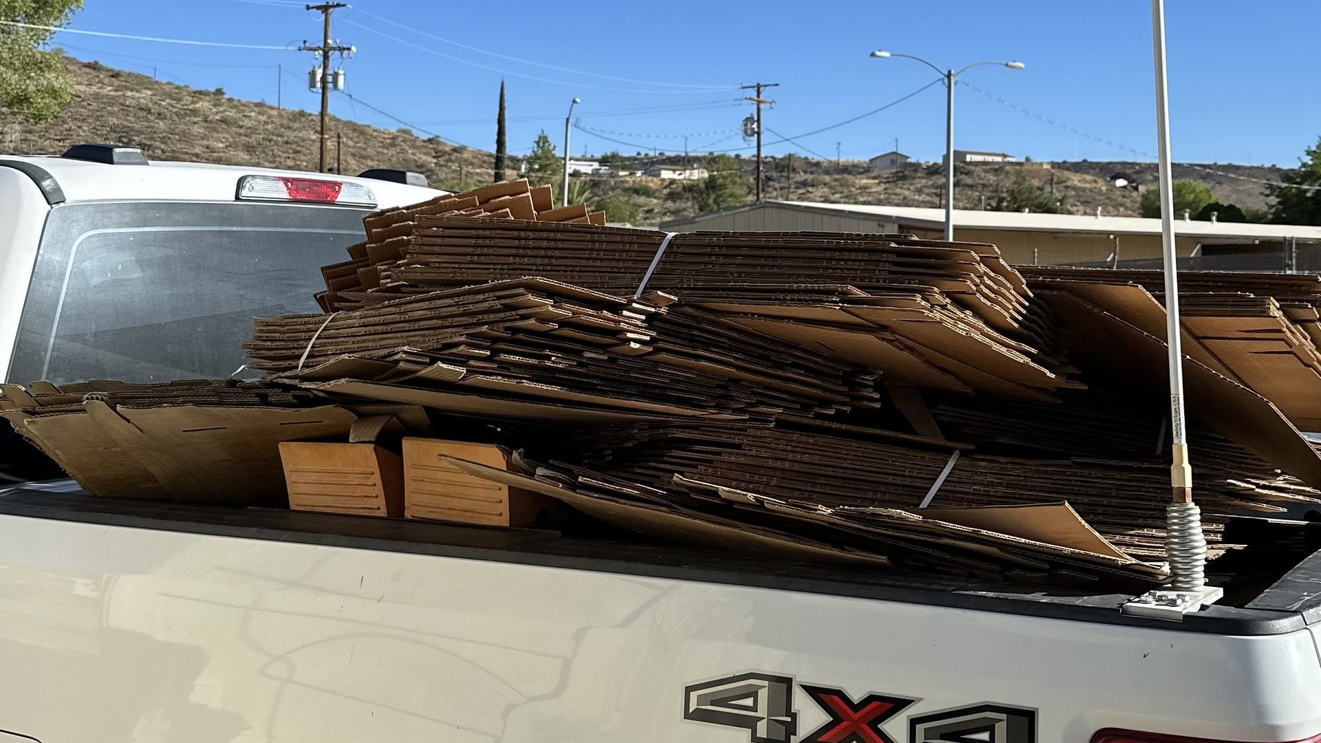 A Trashy Broz work truck loaded with flattened cardboard on a job in Arizona